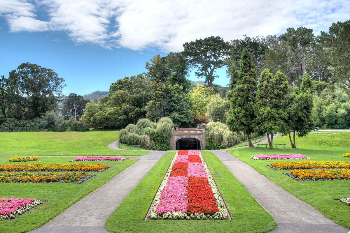 A picturesque park featuring a vibrant flower garden, showcasing a variety of colorful blooms and lush greenery.